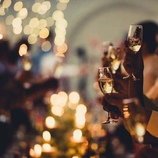 Celebratory Toast with String Lights and Champagne Silhouettes Square stock photo