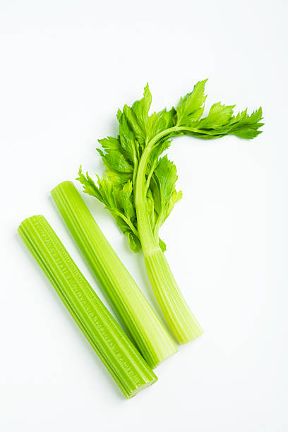 celery stalk with leaves celery stalk with leaves on white celery stock pictures, royalty-free photos & images