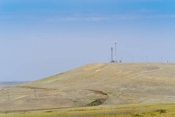 Cellular towers on a hill in the steppe stock photo