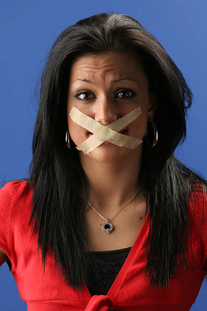 censorship Woman with mouth sealed. human mouth gag adhesive tape women stock pictures, royalty-free photos & images