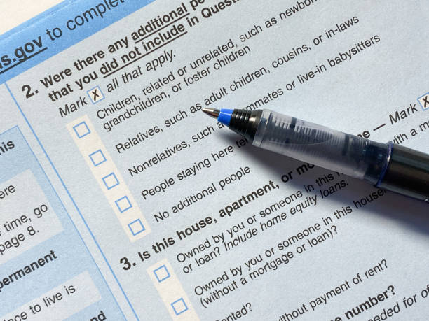 Census 2020: survey questionnaire form on desk with pen Census 2020: survey questionnaire form on desk with pen census stock pictures, royalty-free photos & images