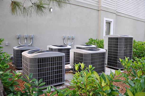 central air conditioning units Several outdoor large central air conditioning units. medium group of objects stock pictures, royalty-free photos & images