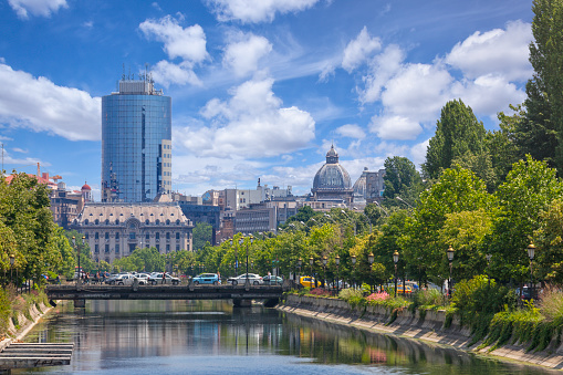 Late spring in Bucharest. View towards the Dambovita river, in the background among other buildings, the tall financial plaza building and the roof of the CEC palace.