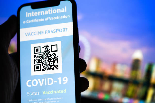 Certificate of Vaccination shows on mobile phone COVID-19 mobile passport certification business travel photos stock pictures, royalty-free photos & images