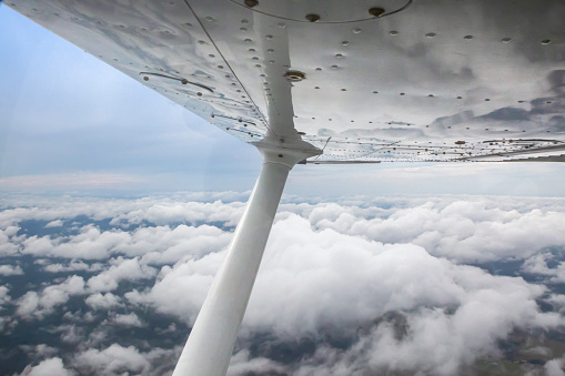 This image is of a wing view of a Cessna 172 Skyhwak. This image is of the interior of the Cessna 172 Skyhawk on the ground at Gold Coast International Airport. The Cessna 172 Skyhawk is equipped with 2 15 inch Garmin G1000 screens. The Cessna 172 Skyhawk is an American four-seat, single-engine, high wing, fixed-wing aircraft made by the Cessna Aircraft Company. First flown in 1955, more 172s have been built than any other aircraft. It was developed from the 1948 Cessna 170 but with tricycle landing gear rather than conventional landing gear.