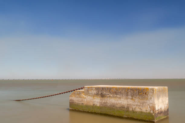 A chained concrete block in a river stock photo