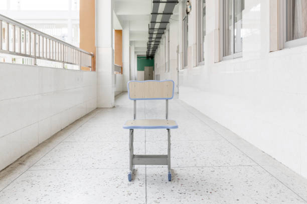 A chair in the hallway of a school classroom stock photo