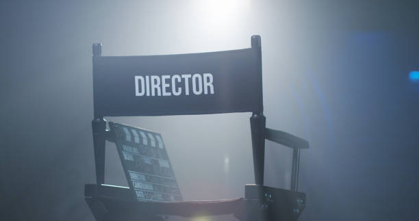 Chair of director with clapboard in spotlight Empty black chair with sign Director and clapperboard in spotlight on filming set director stock pictures, royalty-free photos & images