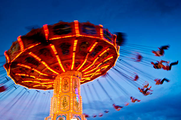 chairoplane at blue hour/sunset Blur motion - chairoplane at blue hour/sunset amusement park ride stock pictures, royalty-free photos & images