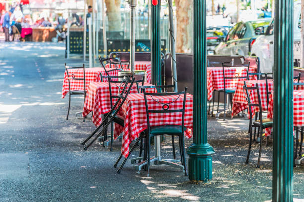Chairs and tables at a outdoor cafe on Lygon Street Chairs and tables at a outdoor cafe on Lygon Street, Carlton, Melbourne, Australia melbourne street stock pictures, royalty-free photos & images