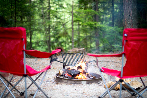 Chairs around the campfire in forest Chairs around a campfire in forest, No people camping chair stock pictures, royalty-free photos & images