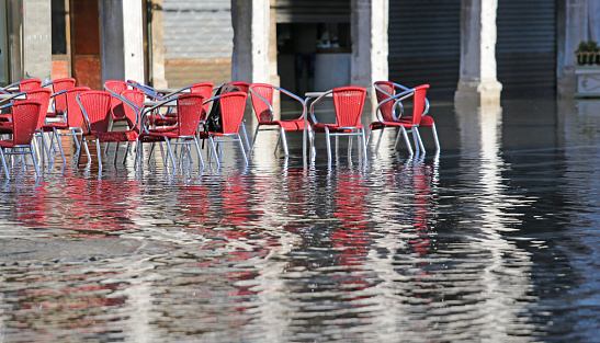 Chairs Of The Outdoor Cafes With Water At High Tide Stock