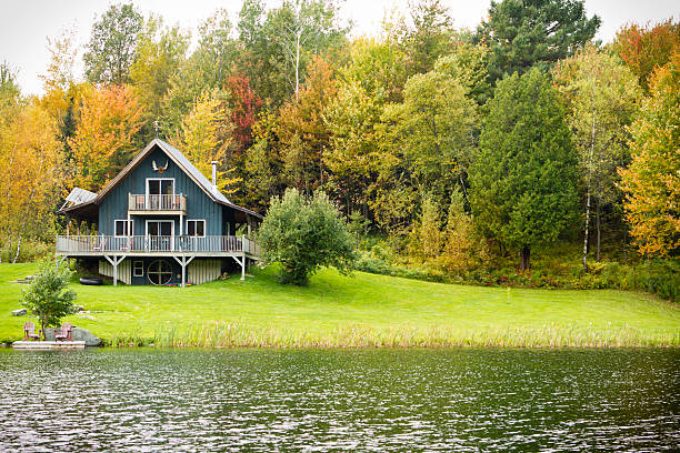 Chalet on A Private Lake With fall Trees stock photo