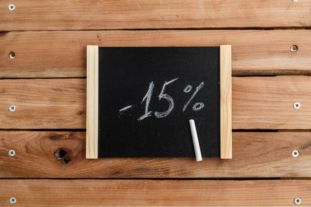 chalk Board with the inscription -15 percent on a wooden background. the view from the top stock photo