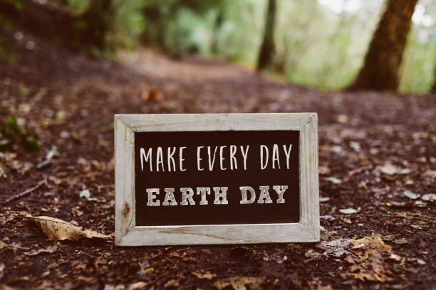 chalkboard with the text make every day earth day closeup of a wooden-framed chalkboard with the text make every day earth day written in it, on the ground in the woods earth day stock pictures, royalty-free photos & images