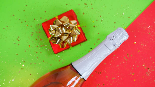 Champagne bottle and gift box on Festive background. stock photo