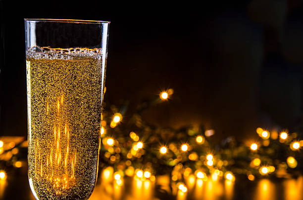 Sparkling wine with soft festive lights in the background.