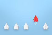 istock Change concepts with red paper airplane leading among white 1353290150