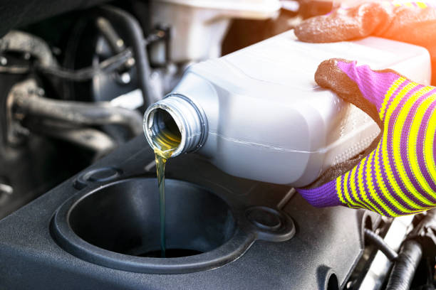 Change the Oil. Hand mechanic in repairing car. Close up oil for car...