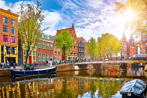 Channel in Amsterdam Netherlands houses river Amstel Channel in Amsterdam Netherlands houses river Amstel landmark old european city spring landscape. canal stock pictures, royalty-free photos & images