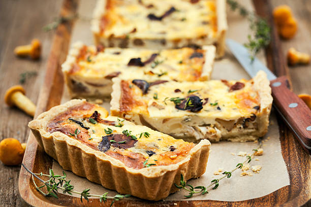 Chanterelle mushroom, cheese and thyme quiche Chanterelle mushroom, cheese and thyme homemade delicious tart (quiche) french food photos stock pictures, royalty-free photos & images
