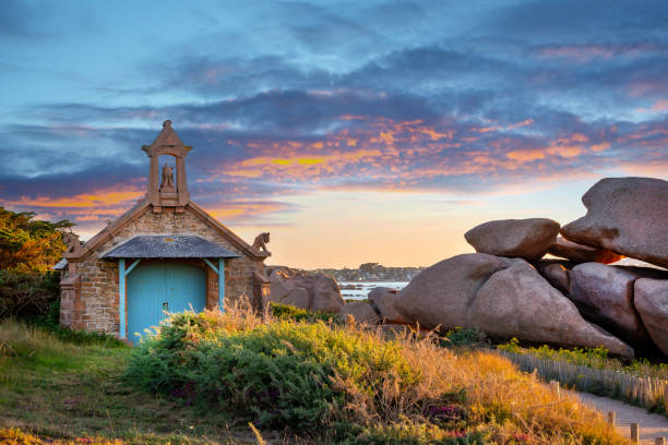 Chapel near Ploumanach at sunset in Perros-Guirec, Côtes d'Armor, Brittany, France stock photo