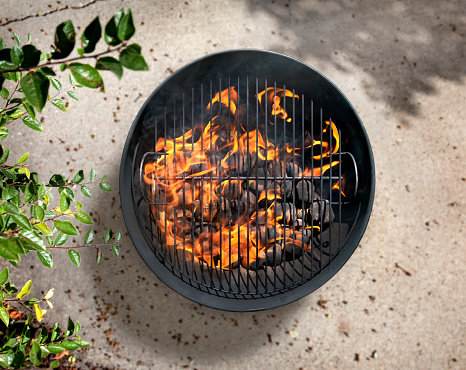 Charcoal Bbq On A Cement Patio Stock Photo - Download Image Now - iStock