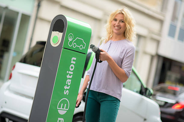 charging electric car - electric car woman bildbanksfoton och bilder