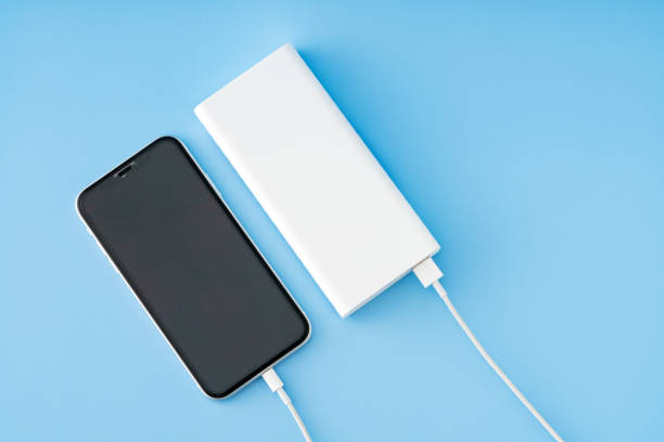 Charging smart phone with power bank stock photo