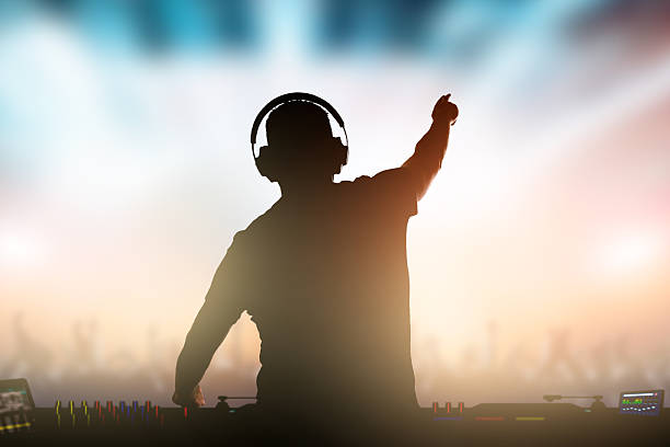 Charismatic disc jockey at the turntable. Charismatic disc jockey. Club, disco DJ playing and mixing music for crowd people. dance music stock pictures, royalty-free photos & images