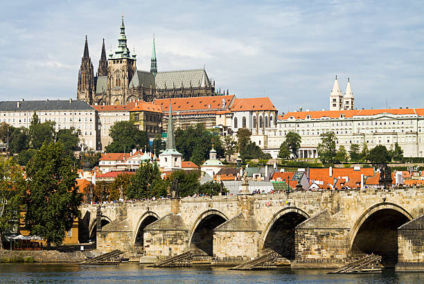 Charles Bridge and Saint Vitus Cathedral in Prague View of Saint Vitus Cathedral and Charles Bridge in Prague. This beautiful Gothic cathedral dominates the skyline in the popular tourist destination of the Czech Republic. hradcany castle stock pictures, royalty-free photos & images