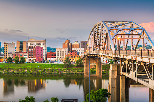 Charleston, West Virginia, USA downtown skyline on the river at dusk.
