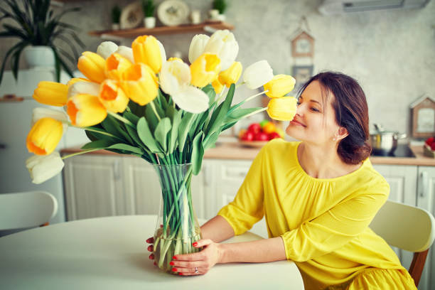Charming, pretty girl is holding a big tulip bouquet in hands stock photo