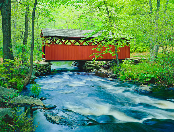 Chatfield Hollow covered bridge, Connecticut Chatfield Hollow covered bridge crosses a fast flowing stream in Chatfield Hollow State Park covered bridge stock pictures, royalty-free photos & images