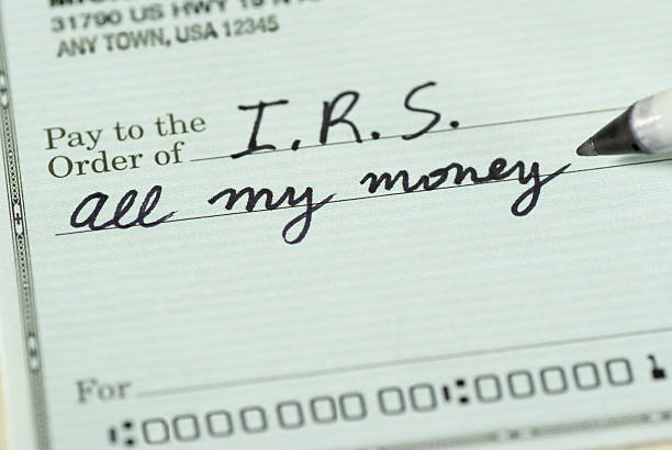 Check to Internal Revenue Service for All My Money Closeup of a check to IRS for All My Money. irs stock pictures, royalty-free photos & images