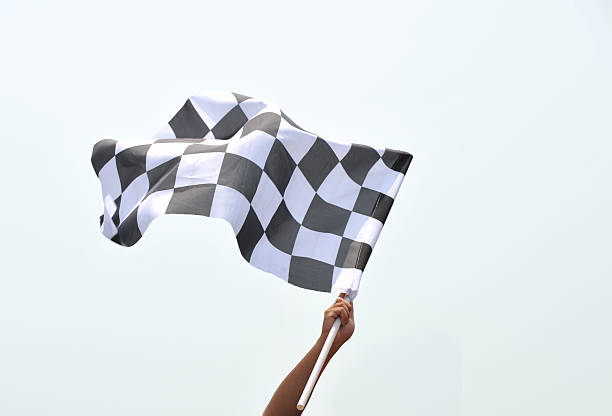 checkered racing flag checkered race flag in hand. finishing photos stock pictures, royalty-free photos & images