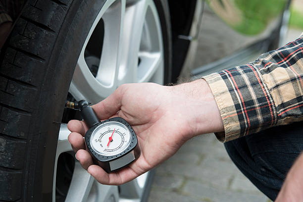 Checking tire pressure stock photo