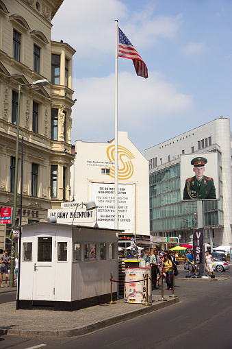 BERLIN, GERMANY - MAY 23, 2014: Tourists around the former Allied Checkpoint Charlie. Nowadays this site is a tourist attraction.