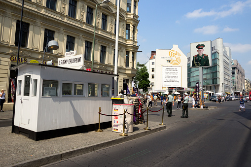BERLIN, GERMANY - MAY 23, 2014: Tourists around the former Allied Checkpoint Charlie. Nowadays this site is a tourist attraction.