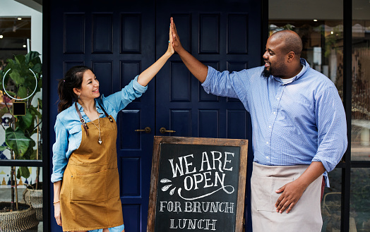 cheerful business owners standing with open blackboard picture id1044280108?b=1&k=20&m=1044280108&s=170667a&w=0&h=qkNN DZ46X36FEanxInXB BckIfQu7W6Kpl2BwkhNkQ= - How to Deal with some of the Most Common Problems in a Restaurant Business￼