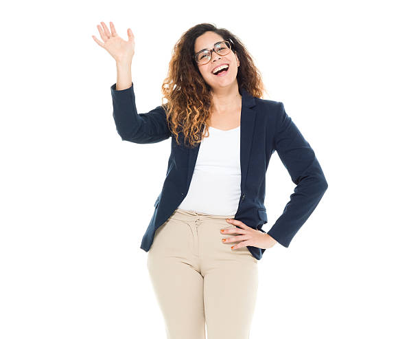 Cheerful businesswoman waving hand stock photo