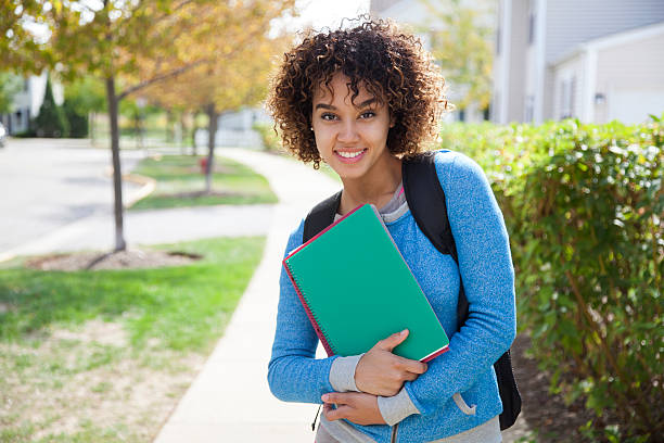 Cheerful college student Cheerful student carrying books. Back to school cute puerto rican girls stock pictures, royalty-free photos & images