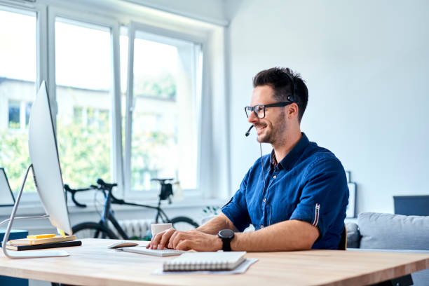 Cheerful consultant working at home stock photo
