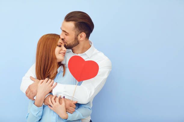 Cheerful couple with paper hearts stock photo