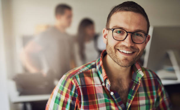 Cheerful entrepreneur wearing glasses in the office stock photo
