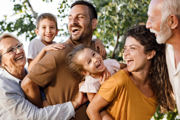 Cheerful extended family having fun in nature. stock photo