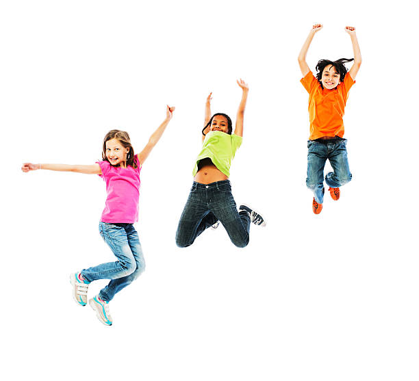 Cheerful kids jumping with arms up. Three happy kids jumping with raised arms. They are isolated on white. boy jumping stock pictures, royalty-free photos & images