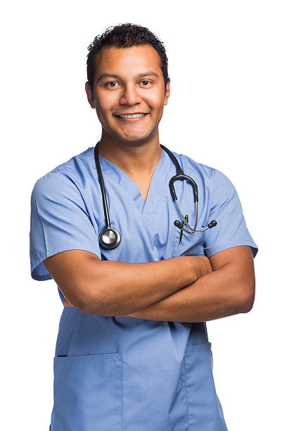 Cheerful latin nurse arms crossed A cheerful latin nurse with his arms crossed. medium shot stock pictures, royalty-free photos & images