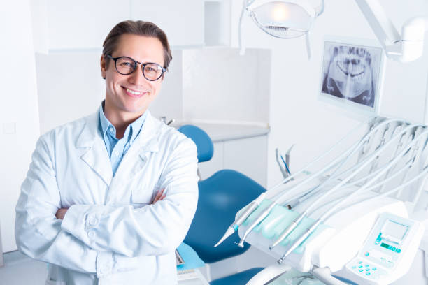 Cheerful male man dentist at dentist office stock photo