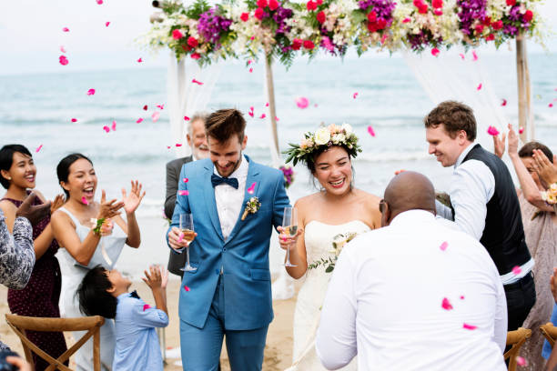 Cheerful newlyweds at beach wedding ceremnoy Cheerful newlyweds at beach wedding ceremnoy wedding reception stock pictures, royalty-free photos & images